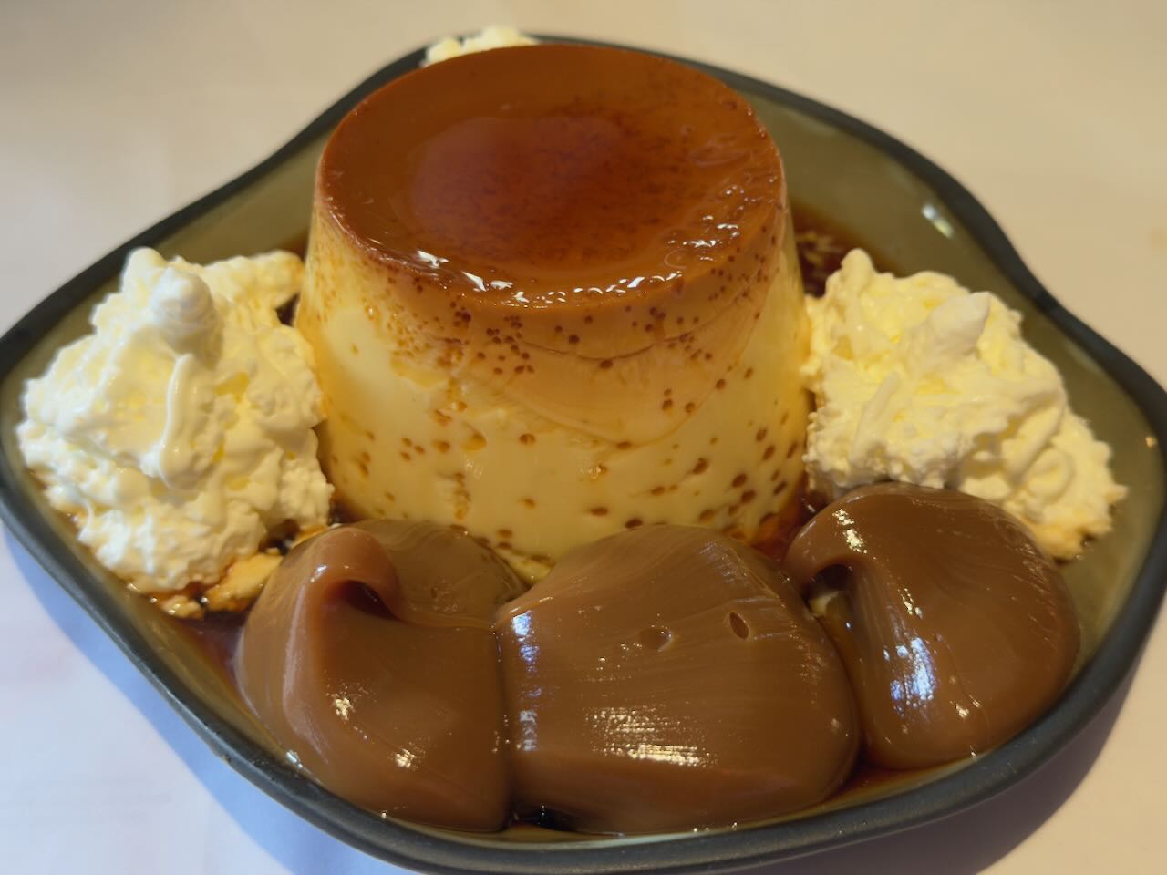 Classic Caramel Flan with Whipped Cream and Dulce de Leche